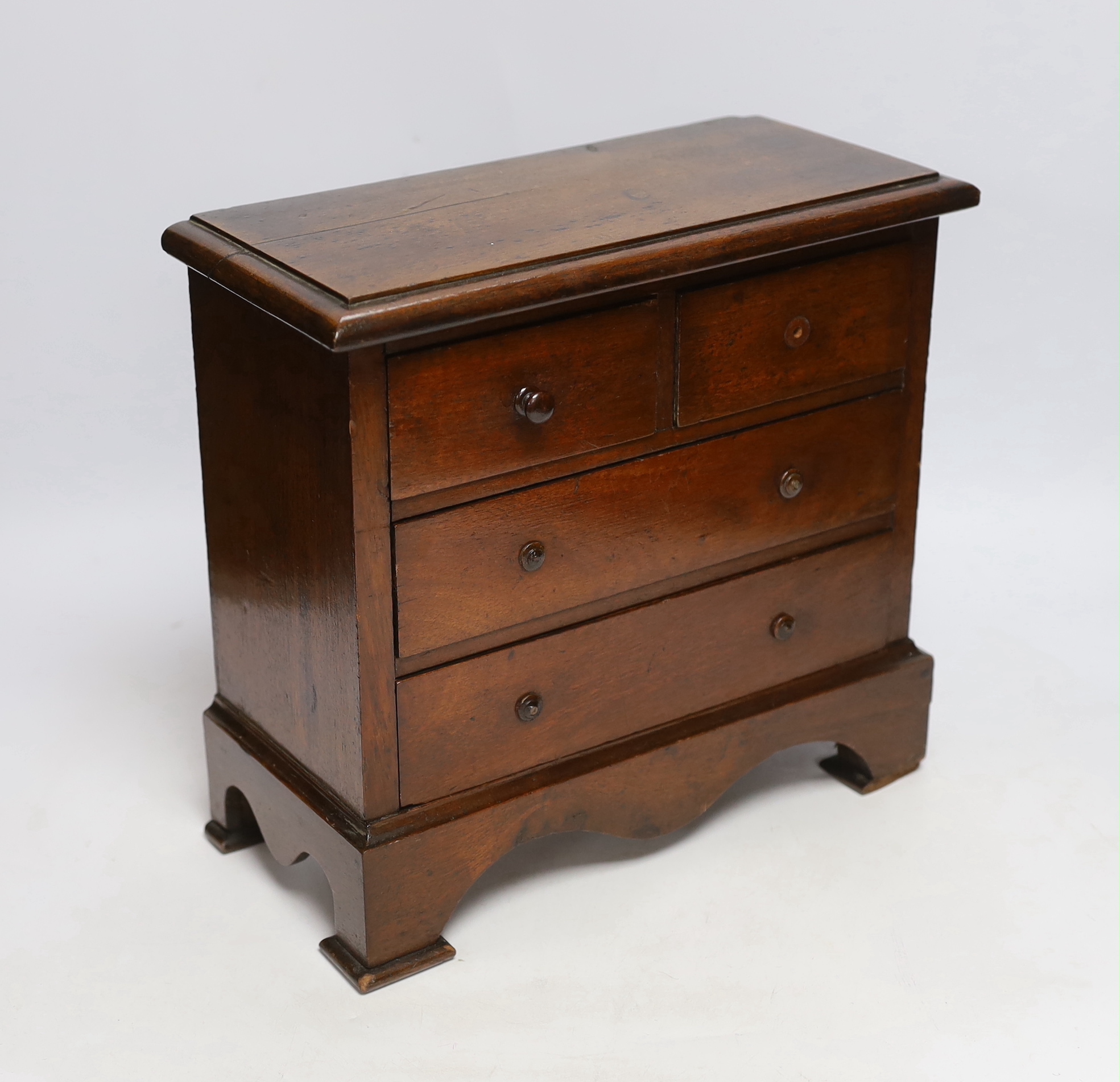 A Victorian miniature mahogany chest of drawers, 26cm high x 28cm wide